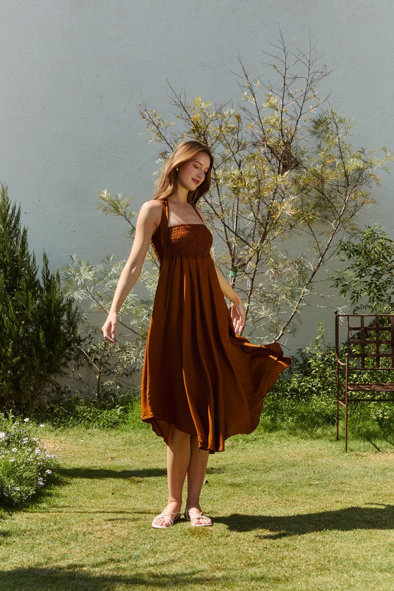 Creator styling a flowing caramel skirt outdoors